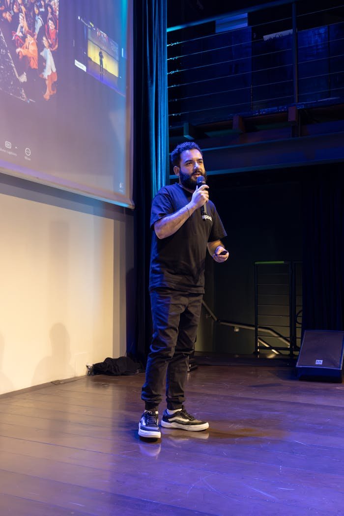 A speaker giving a presentation on stage during a conference.